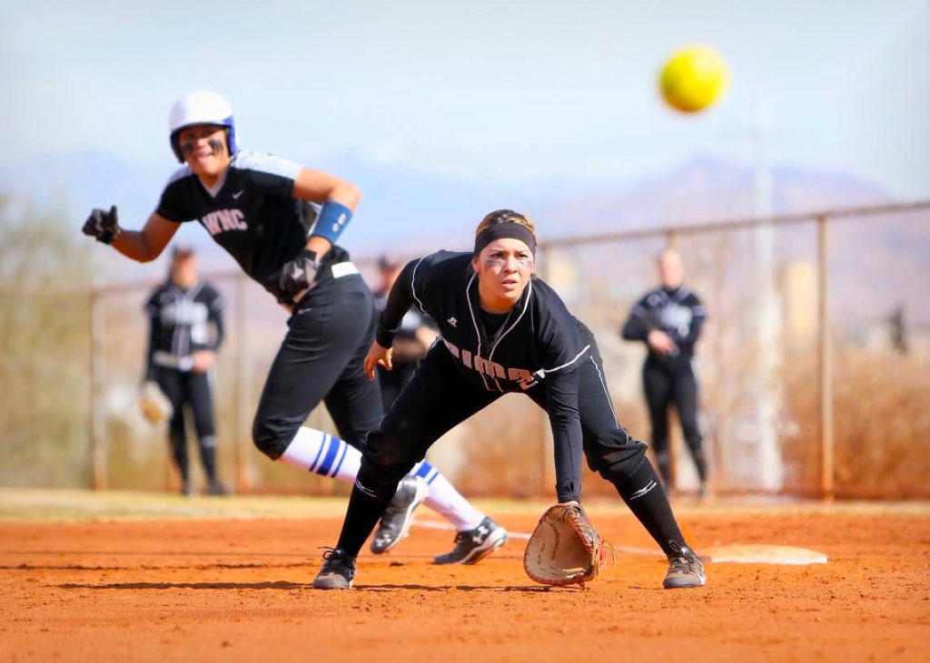 Aztec softball pitcher watches the ball closely
