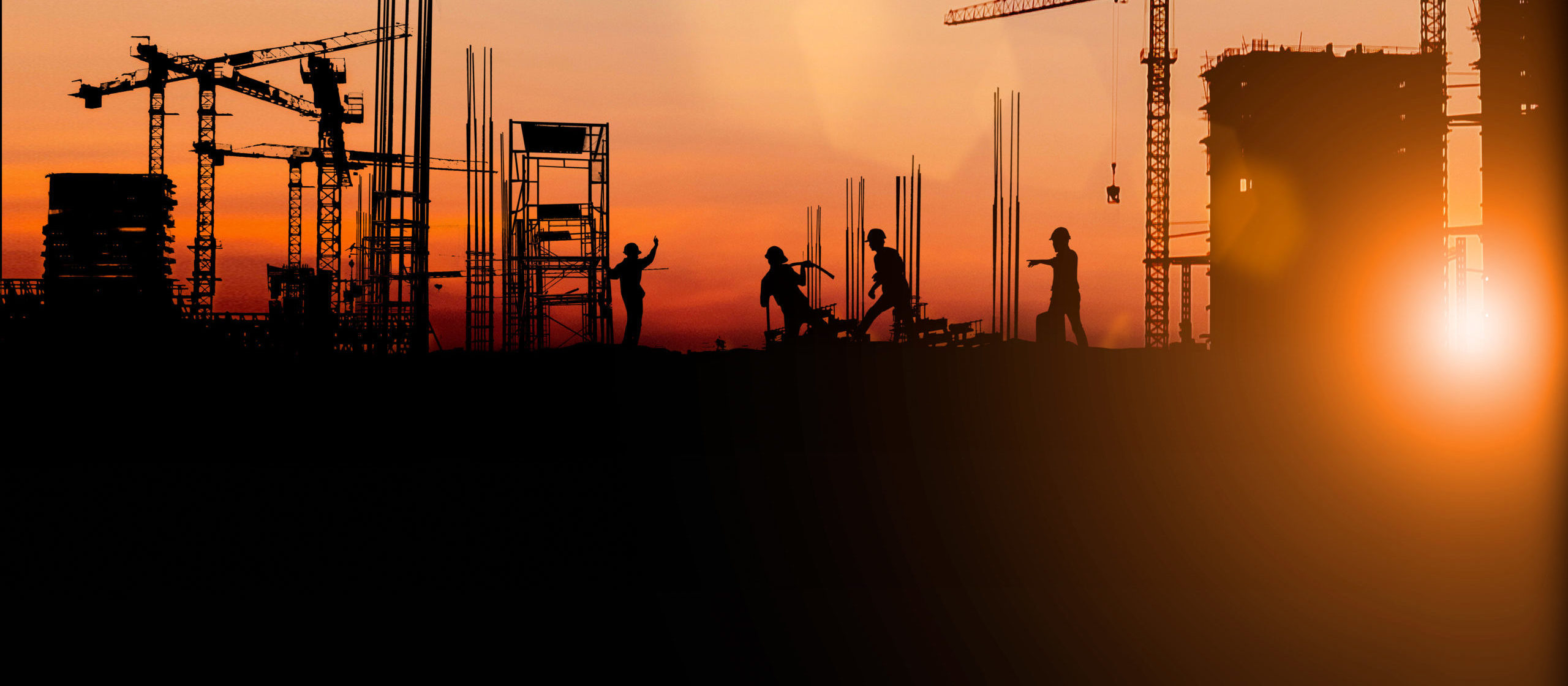 Silhouette of Survey Engineer and construction team working at site over blurred industry background with Light fair Film Grain effect.